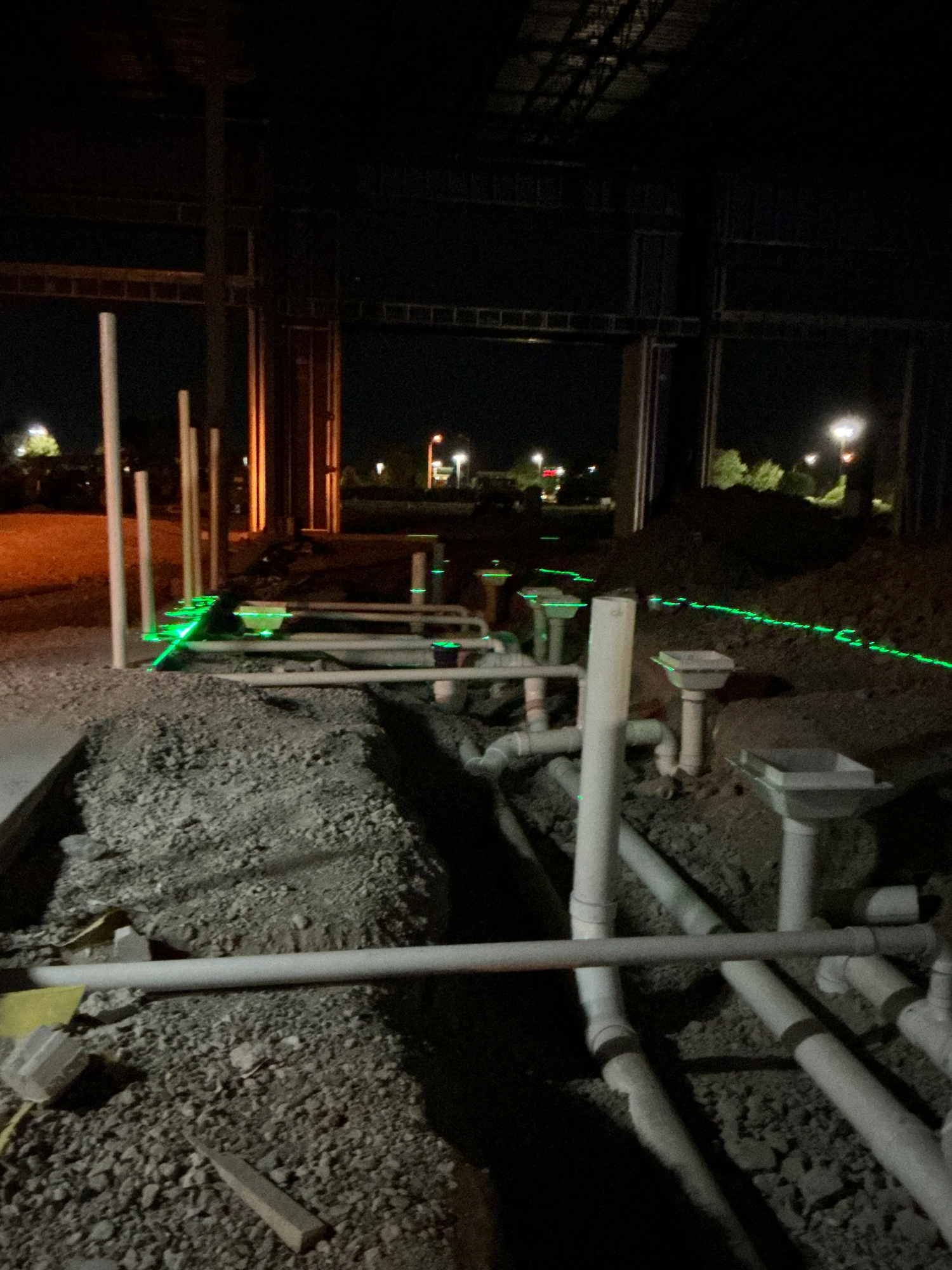 Meza Plumbing crew roughing in underground drain lines on a commercial job